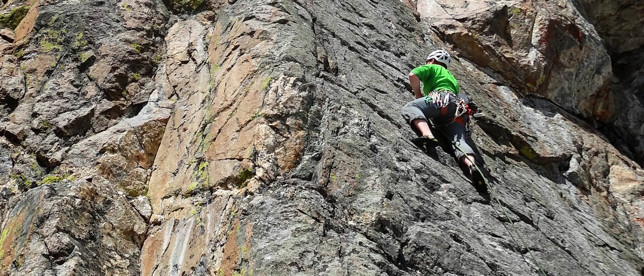 Climber on the bottom pitch of Direct Exum Arête at Rock Springs Buttress, Jackson Hole